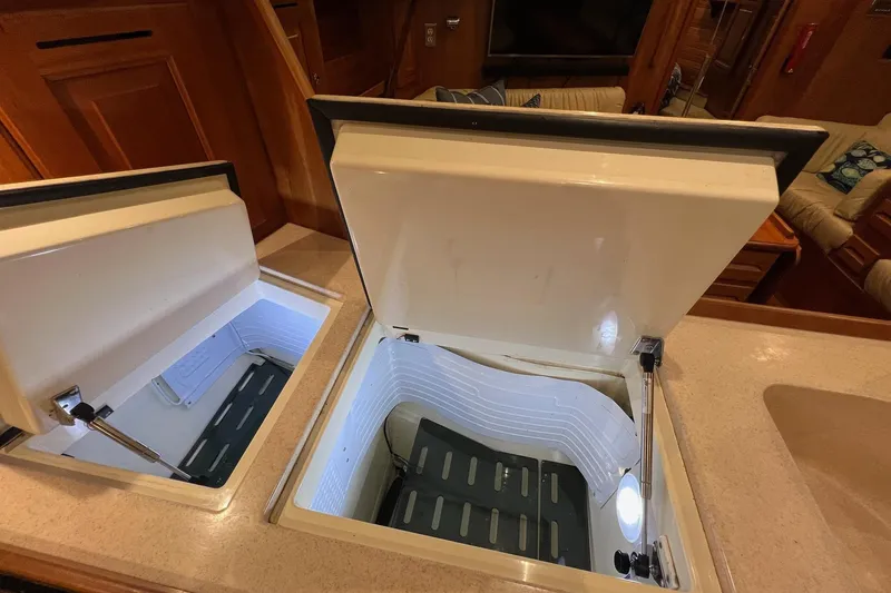 Slide: The Image of Open storage compartments in a 2017 Tartan 4300 yacht interior. - 43