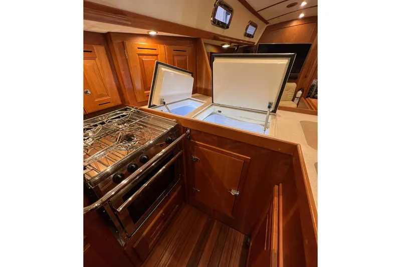 Slide: The Image of Luxurious 2017 Tartan 4300 yacht kitchen with stove and open fridge. - 44