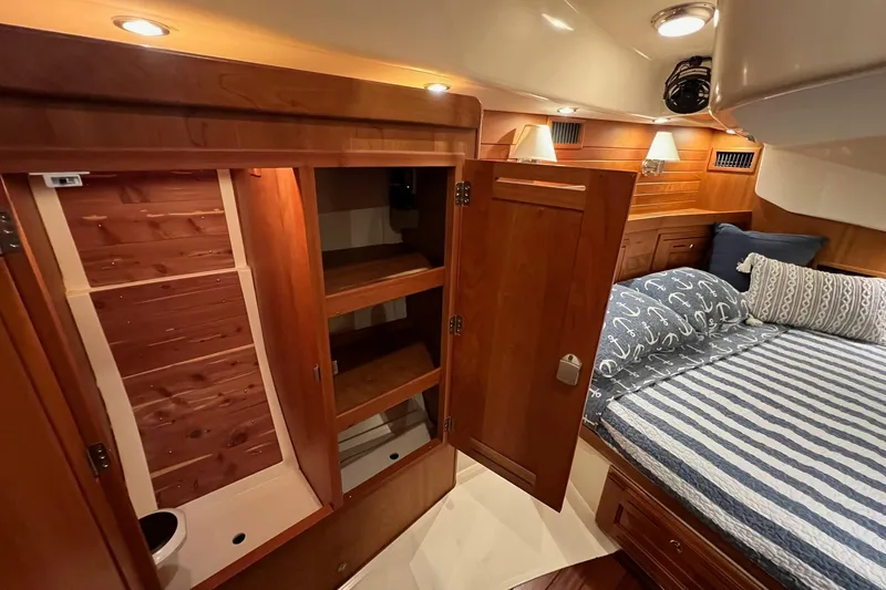 Slide: The Image of Luxurious 2017 Tartan 4300 yacht cabin with wooden cabinetry and cozy bedding. - 57