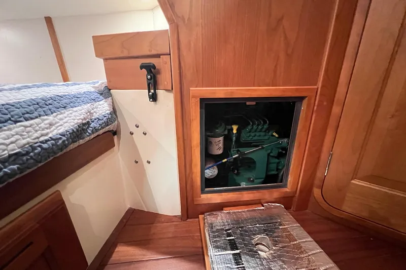 Slide: The Image of Interior of a 2017 Tartan 4300 sailboat showing engine access panel and wooden cabinetry. - 61