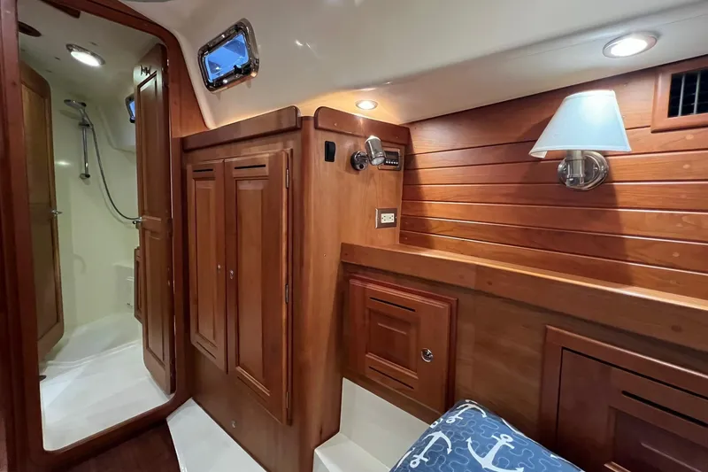 Slide: The Image of Luxurious 2017 Tartan 4300 yacht interior with wooden cabinetry and cozy lighting. - 62