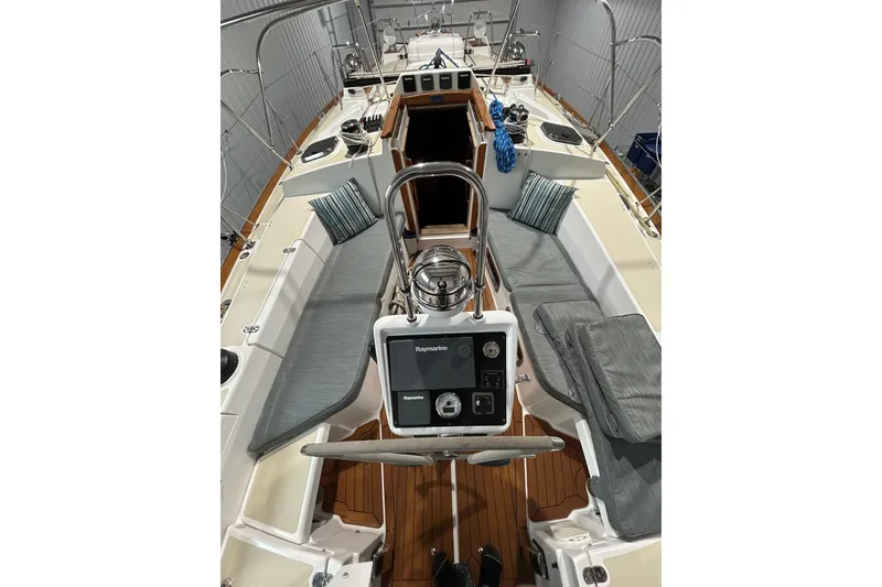 Slide: The Image of 2017 Tartan 4300 sailboat interior with cushioned seating and navigation equipment. - 66