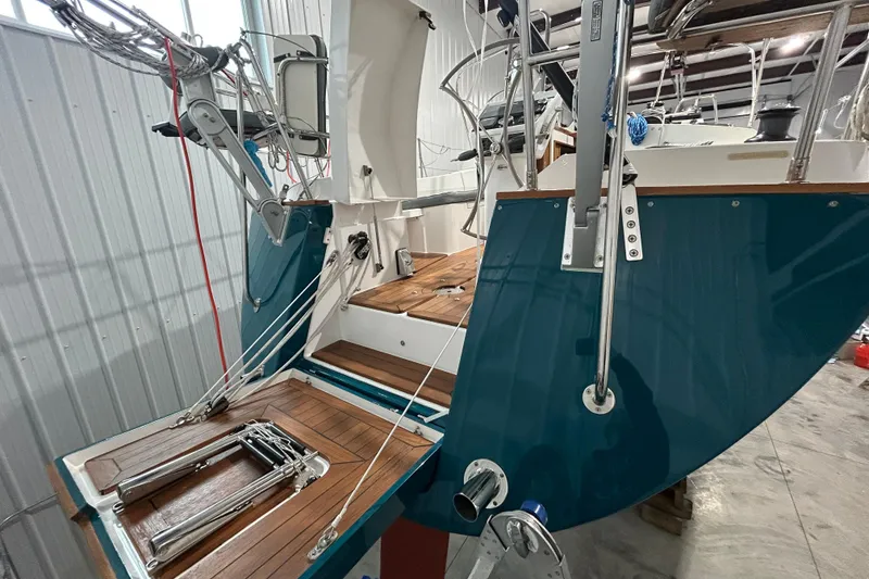 Slide: The Image of 2017 Tartan 4300 sailboat in a warehouse, showcasing its deck and rigging. - 67