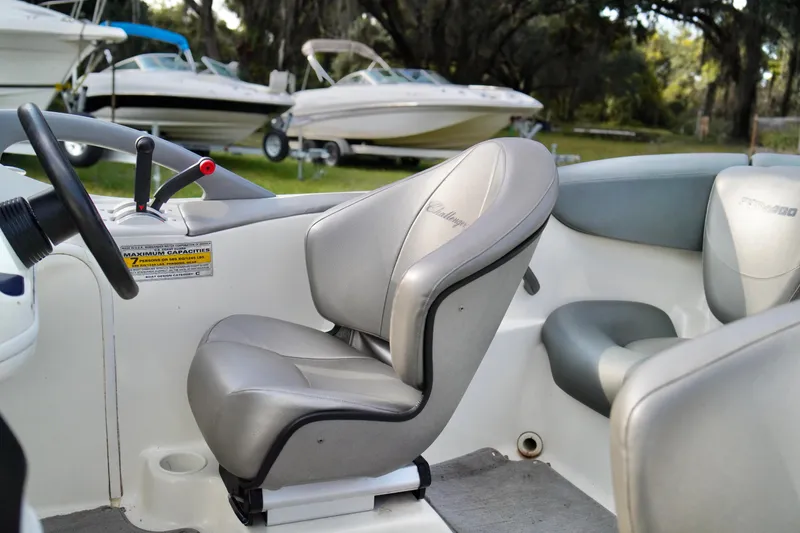 Slide: The Image of Interior of a 2001 Bombardier 1800 Challenger boat with gray seating. - 11