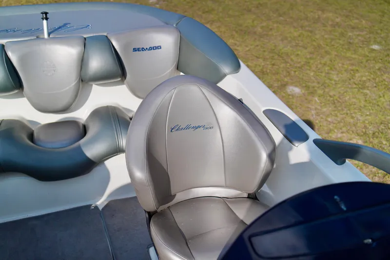 Slide: The Image of Interior of a 2001 Bombardier 1800 Challenger boat with gray seating. - 21