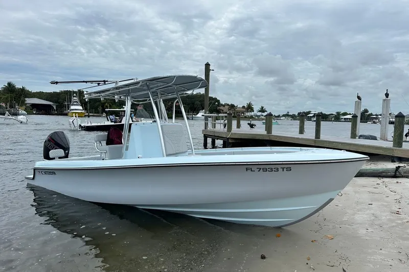 The Image of 2024 Contender 24 Sport boat docked by the shore on a cloudy day. - 0