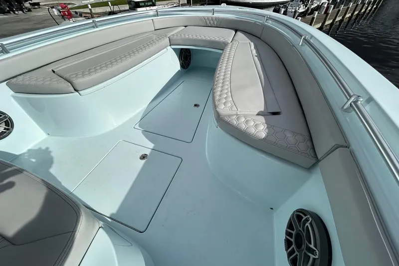 Slide: The Image of 2024 Contender 24 Sport boat interior with cushioned seating and storage compartments. - 12