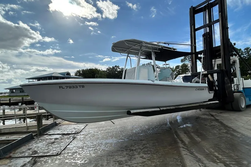 Slide: The Image of 2024 Contender 24 Sport boat on forklift under cloudy sky. - 4