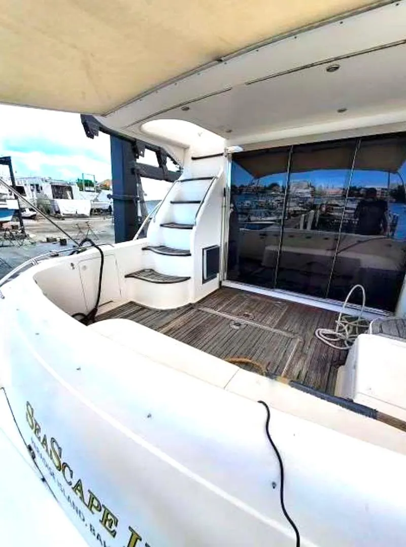 Slide: The Image of 1998 Viking Sports Cruiser yacht with spacious deck and elegant staircase. - 10