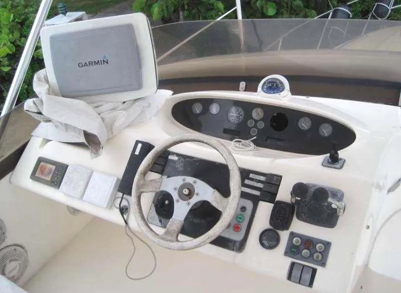Slide: The Image of 1998 Viking Sports Cruiser dashboard with Garmin GPS, steering wheel, and control panel. - 14