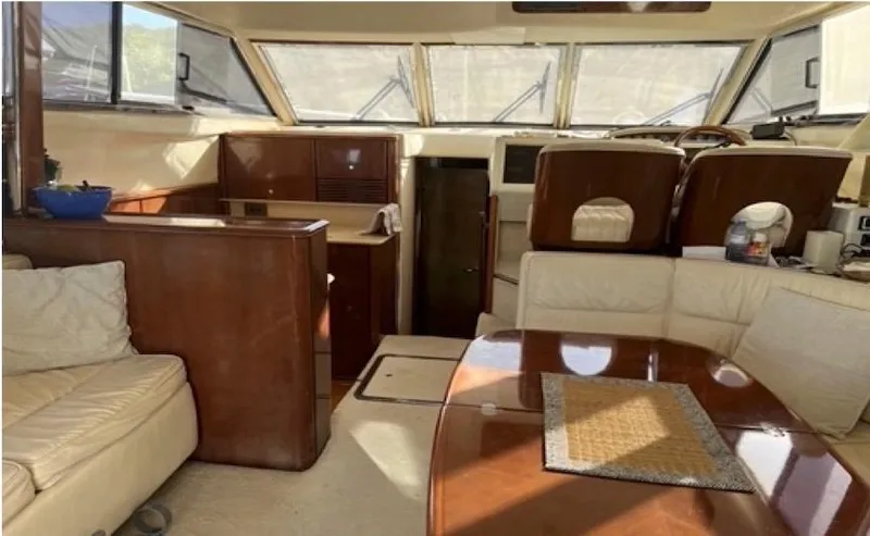 Slide: The Image of Interior of a 1998 Viking Sports Cruiser with wood accents and cream seating. - 17