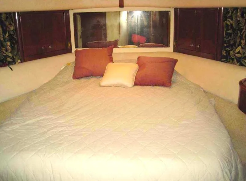 Slide: The Image of Cozy bedroom in 1998 Viking Sports Cruiser with pillows and quilted bedding. - 18