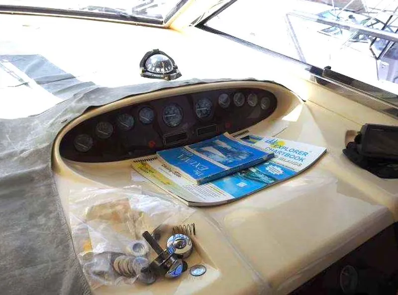 Slide: The Image of Control panel of a 1998 Viking Sports Cruiser with navigation charts and accessories. - 23