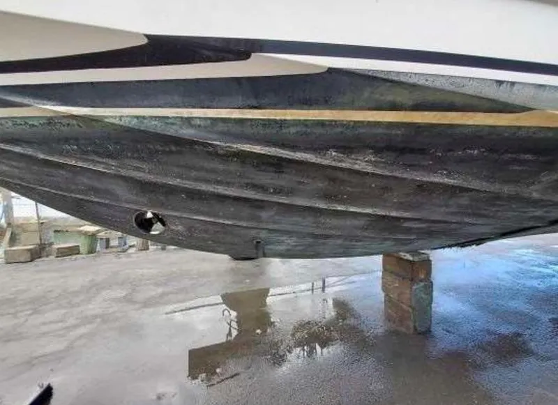 Slide: The Image of 1998 Viking Sports Cruiser hull, dry docked, showing underside details and condition. - 28
