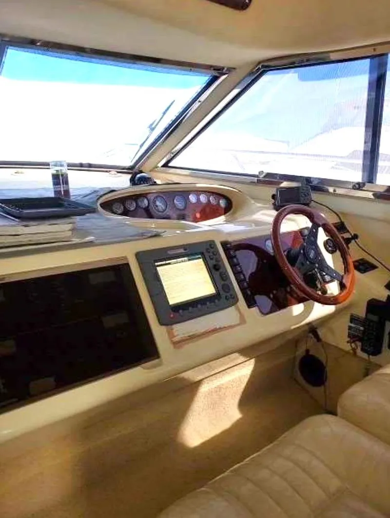 Slide: The Image of Interior cockpit of a 1998 Viking Sports Cruiser with navigation equipment and steering wheel. - 30