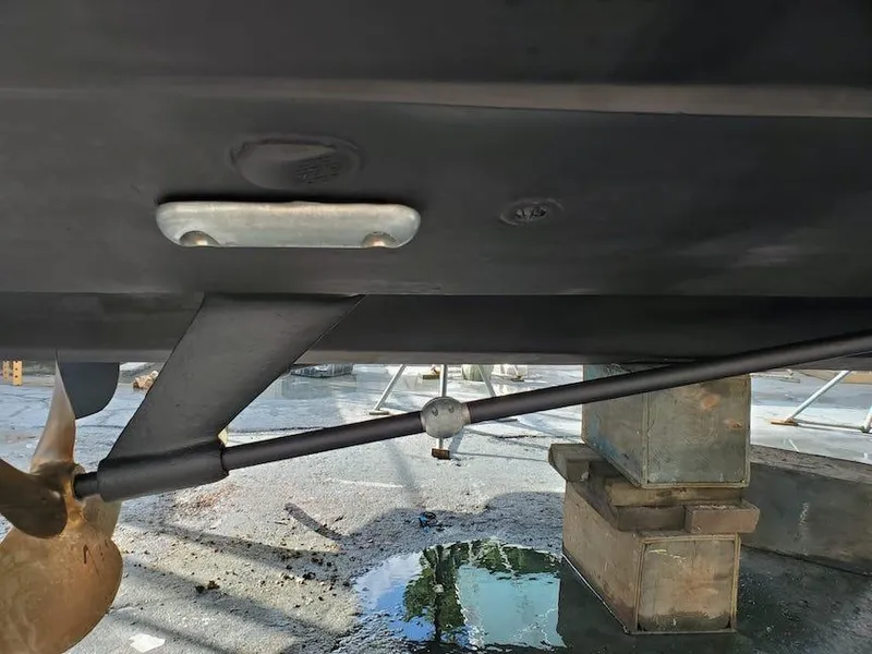 Slide: The Image of 1998 Viking Sports Cruiser underside with propeller and rudder components visible. - 35