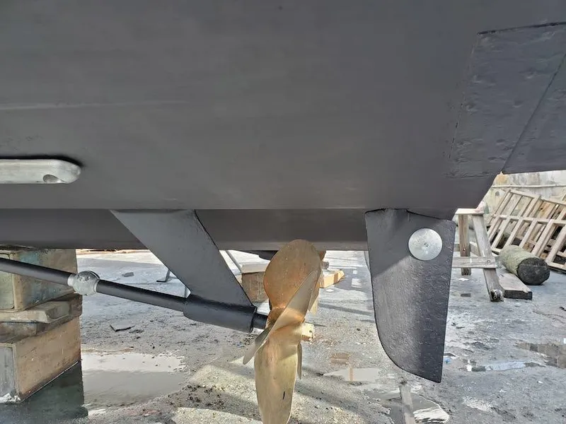 Slide: The Image of 1998 Viking Sports Cruiser propeller and rudder detail in dry dock. - 36