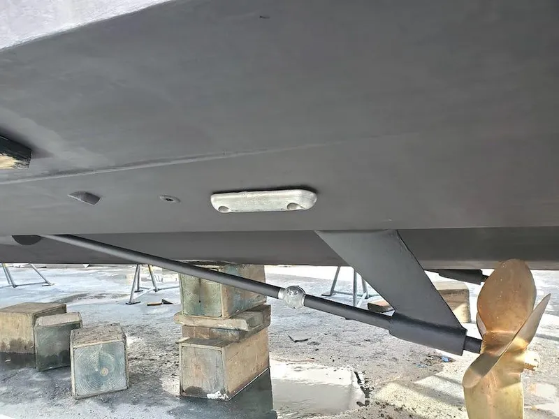 Slide: The Image of Underneath view of a 1998 Viking Sports Cruiser with visible propeller and support blocks. - 38