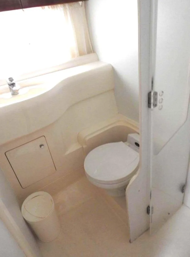 Slide: The Image of 1998 Viking Sports Cruiser bathroom interior with toilet and sink. - 9