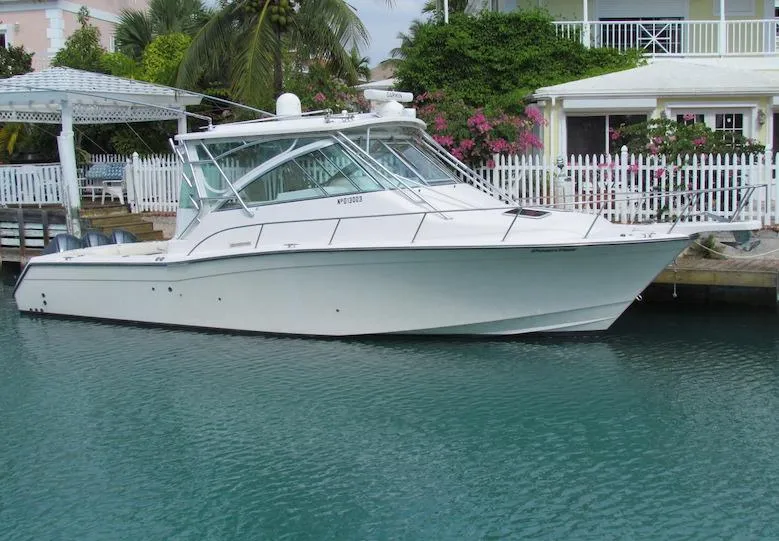 The Image of 2008 Grady-White Express 360 boat docked by a waterfront home. - 0