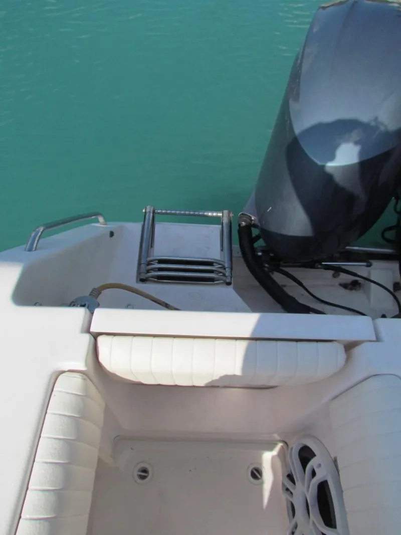 Slide: The Image of 2008 Grady-White Express 360 boat stern with ladder and engine in turquoise water. - 15