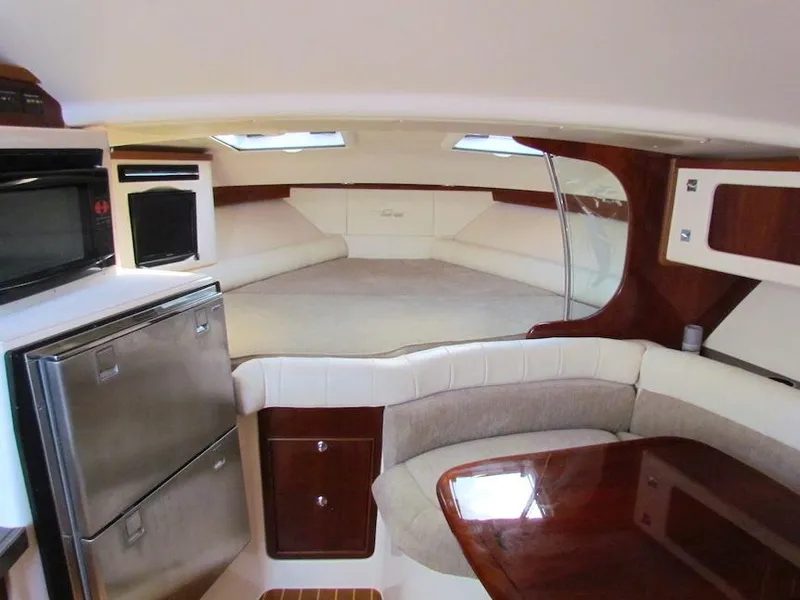 Slide: The Image of 2008 Grady-White Express 360 cabin interior with kitchenette and seating area. - 18