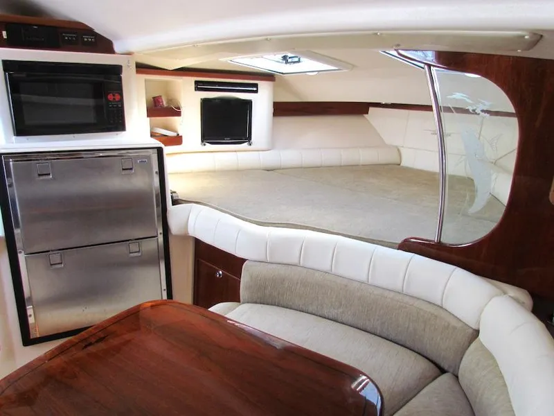 Slide: The Image of 2008 Grady-White Express 360 cabin interior with bed, seating, and kitchenette. - 20