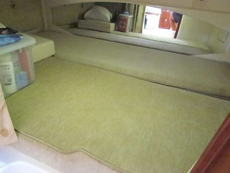 Slide: The Image of 2008 Grady-White Express 360 cabin interior with beige bedding and storage. - 22