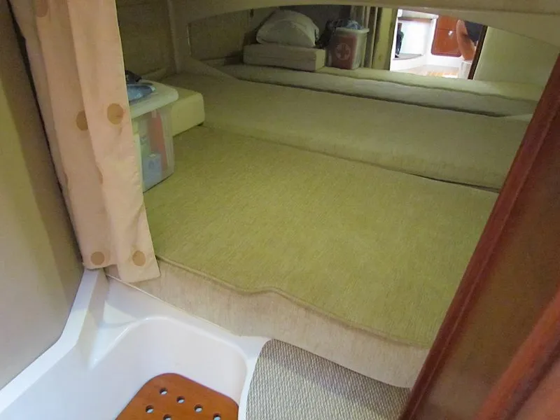 Slide: The Image of 2008 Grady-White Express 360 cabin interior with bed and storage area. - 23