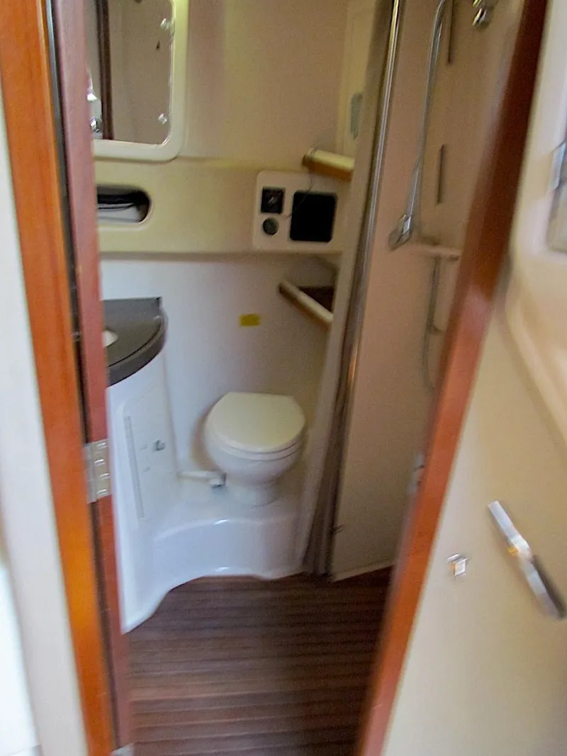 Slide: The Image of 2008 Grady-White Express 360 boat bathroom with wooden flooring and compact design. - 24