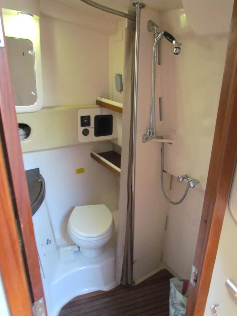 Slide: The Image of 2008 Grady-White Express 360 boat bathroom with shower, toilet, and wooden flooring. - 25