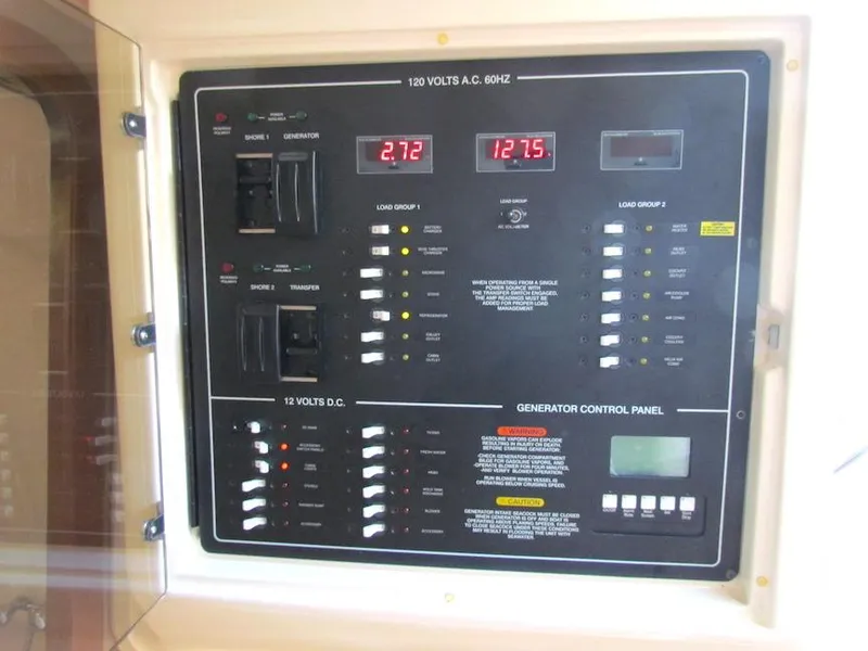 Slide: The Image of Control panel of a 2008 Grady-White Express 360 boat, showing voltage and generator settings. - 26