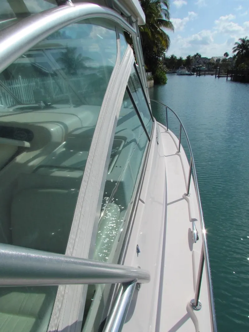 Slide: The Image of 2008 Grady-White Express 360 yacht on a serene waterway, palm trees in the background. - 30