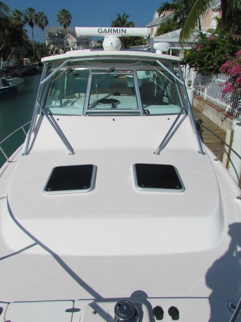 Slide: The Image of 2008 Grady-White Express 360 boat with Garmin radar, docked near tropical foliage. - 31
