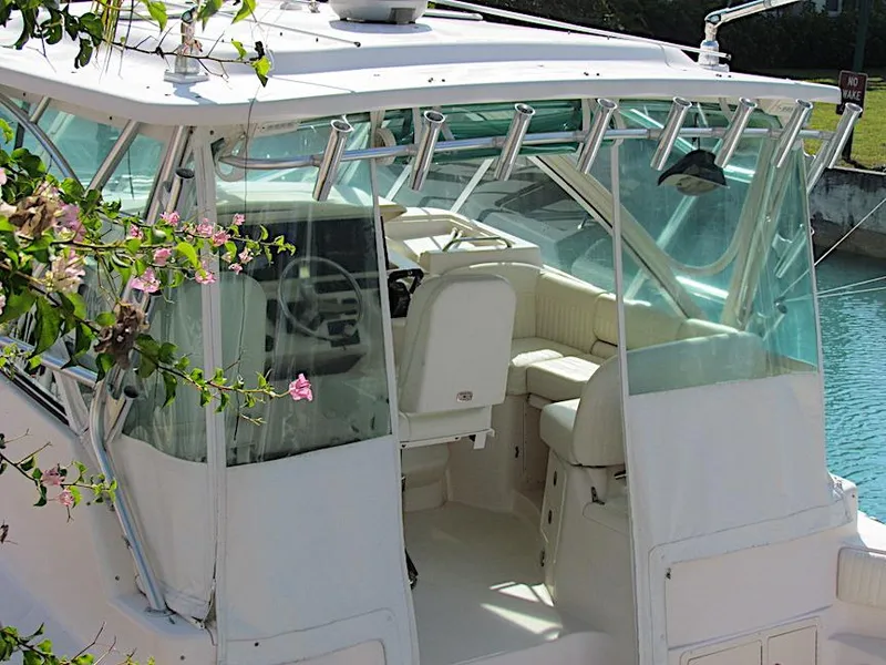 Slide: The Image of 2008 Grady-White Express 360 boat interior with helm, white seating, and floral foreground. - 5