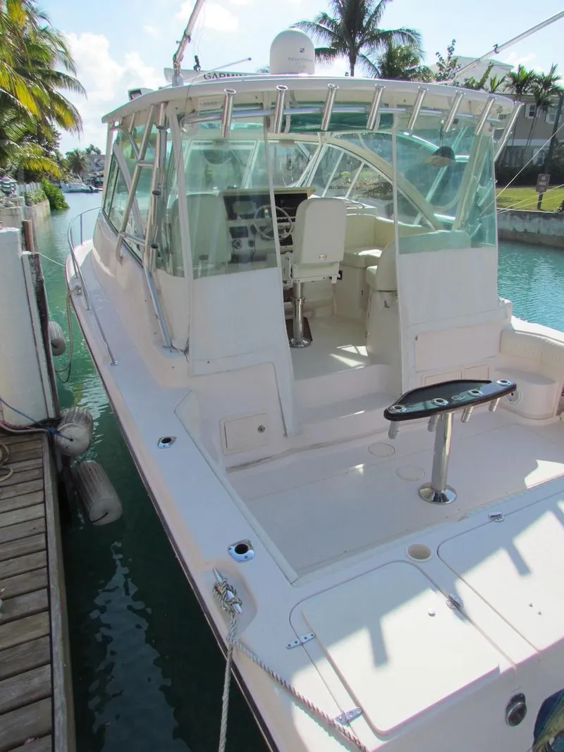 Slide: The Image of 2008 Grady-White Express 360 boat docked on a sunny day, featuring spacious cockpit and helm. - 6