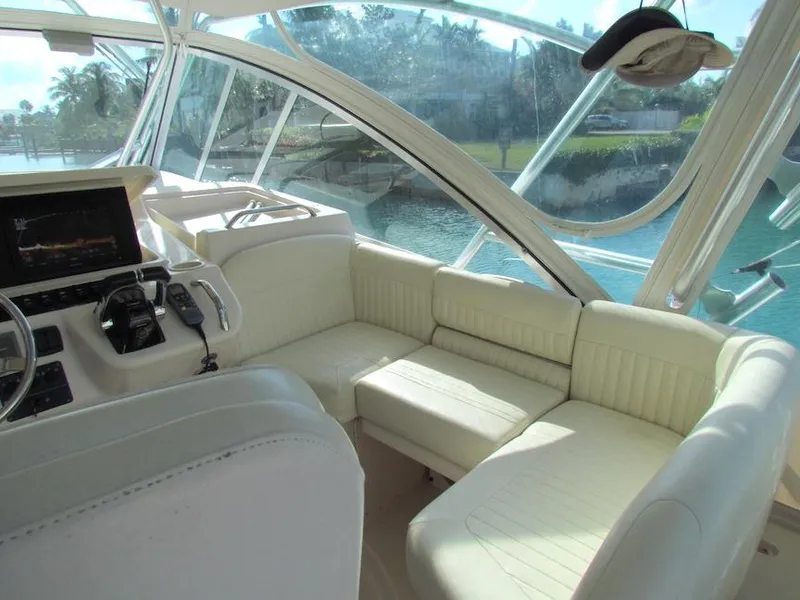 Slide: The Image of Interior of 2008 Grady-White Express 360 boat with white seating and helm controls. - 9