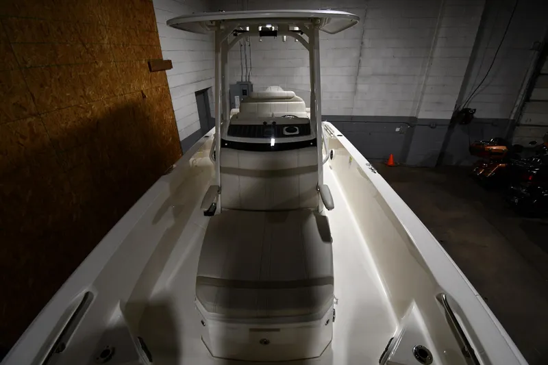 Slide: The Image of 2022 Boston Whaler 250 Dauntless boat interior in a dimly lit garage. - 14