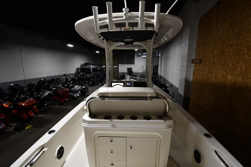 Slide: The Image of 2022 Boston Whaler 250 Dauntless boat interior with rod holders and storage compartments. - 15