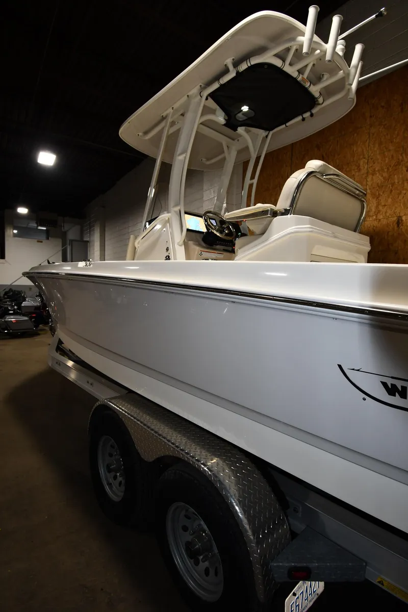 Slide: The Image of 2022 Boston Whaler 250 Dauntless boat on trailer in indoor storage. - 2