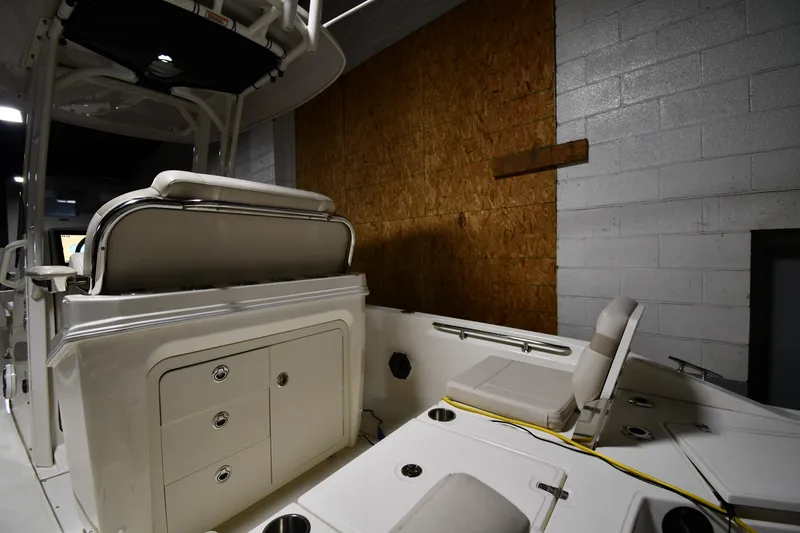 Slide: The Image of 2022 Boston Whaler 250 Dauntless boat interior in a dimly lit storage area. - 22