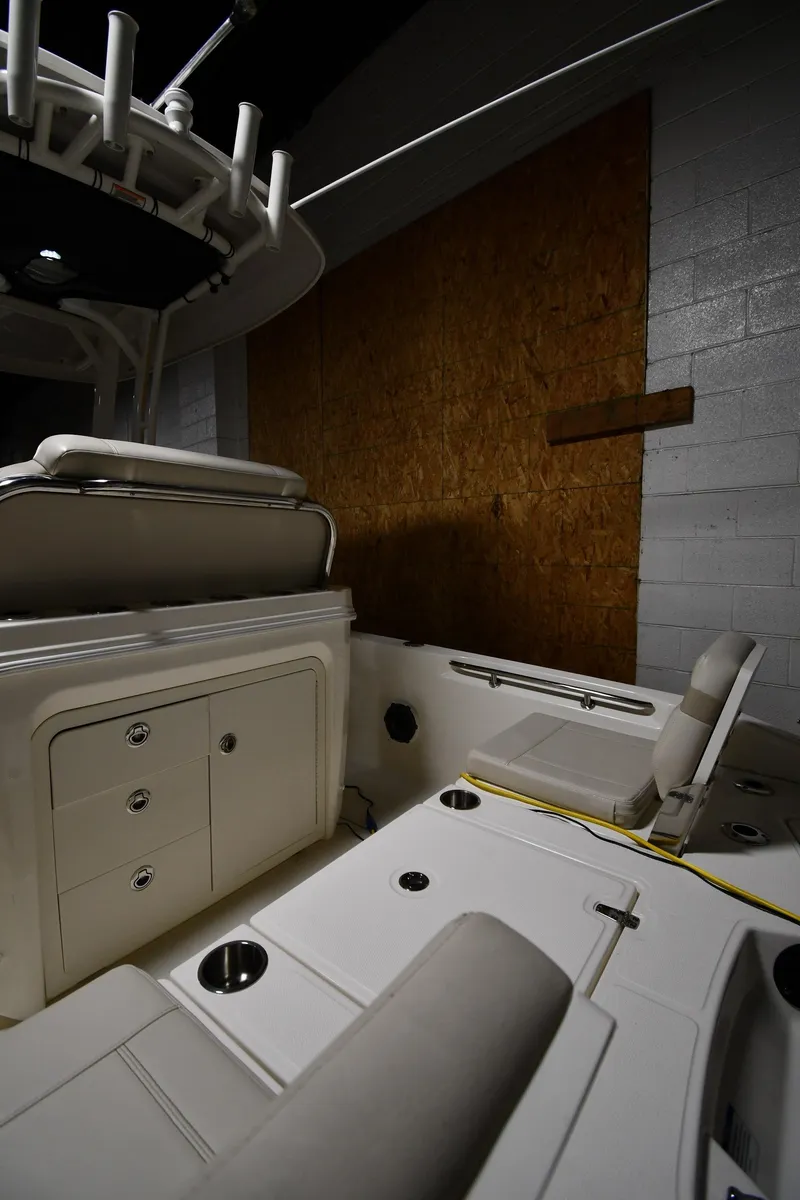 Slide: The Image of 2022 Boston Whaler 250 Dauntless interior, showcasing seating and storage compartments. - 23