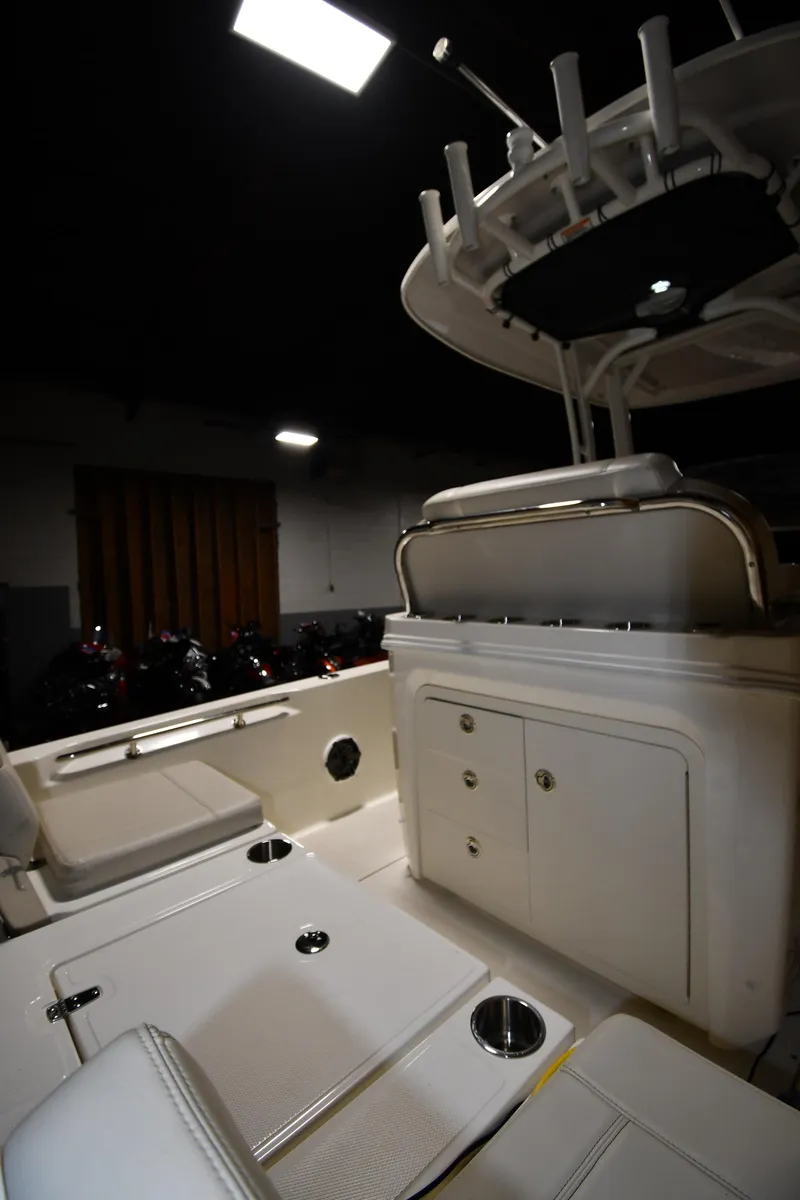 Slide: The Image of 2022 Boston Whaler 250 Dauntless interior with seating and storage compartments. - 25