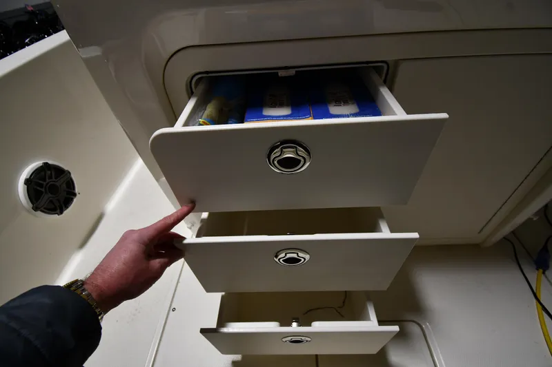 Slide: The Image of Storage drawers on a 2022 Boston Whaler 250 Dauntless boat interior. - 29