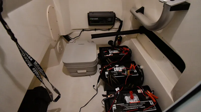 Slide: The Image of Interior of 2022 Boston Whaler 250 Dauntless showing batteries and equipment. - 44