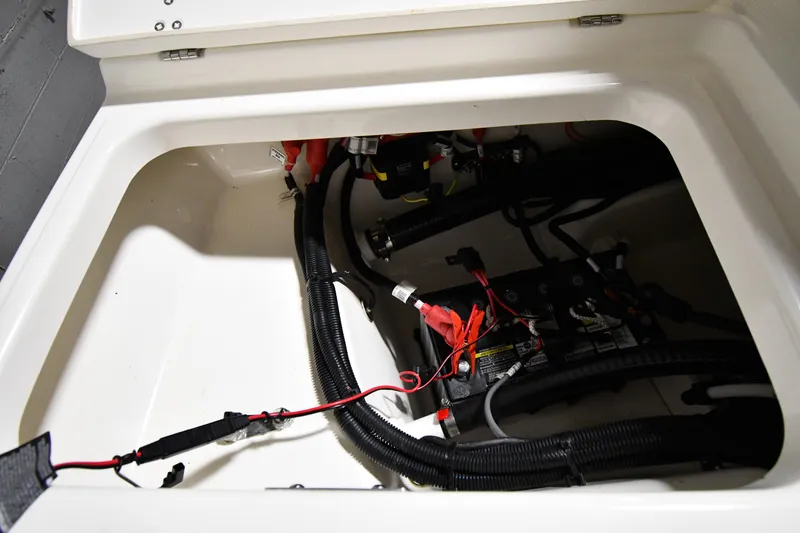 Slide: The Image of 2022 Boston Whaler 250 Dauntless battery compartment with wiring and connections. - 46