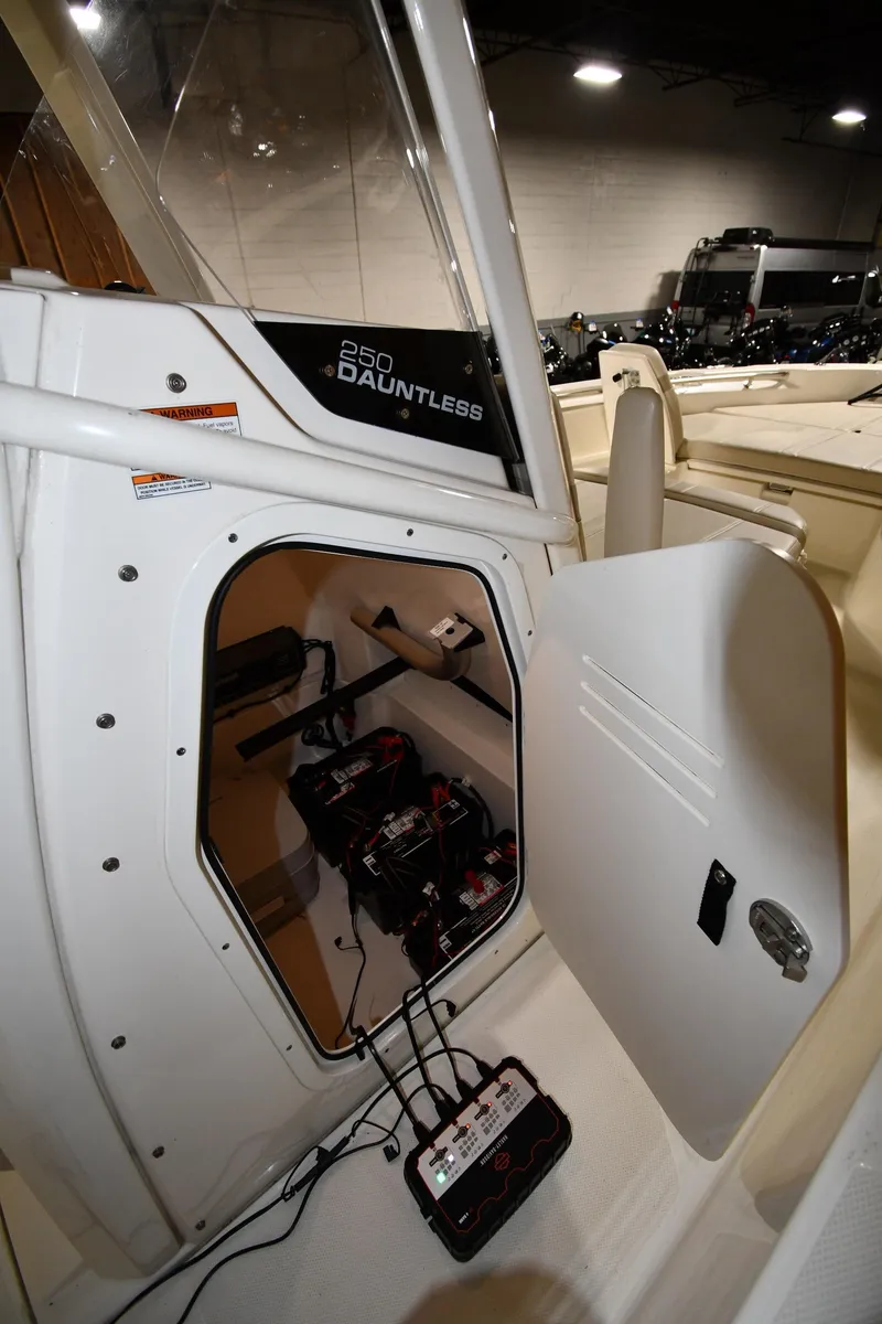 Slide: The Image of 2022 Boston Whaler 250 Dauntless boat interior with open storage compartment. - 48