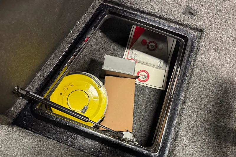 Slide: The Image of Storage compartment in 2026 Nitro ZV20 Sport Pro boat with various items inside. - 19