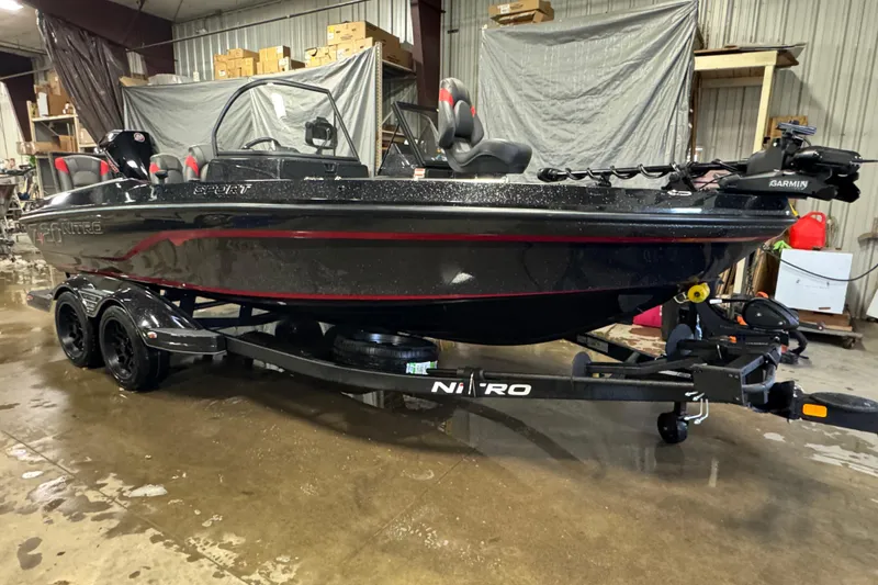 Slide: The Image of 2026 Nitro ZV20 Sport Pro boat in a garage, on a trailer, with sleek black design. - 2