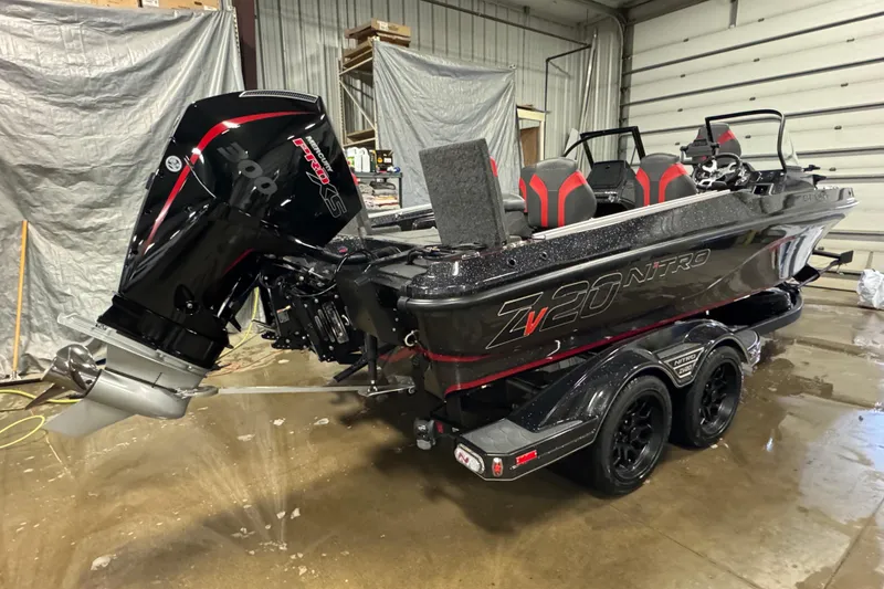 Slide: The Image of 2026 Nitro ZV20 Sport Pro boat with powerful outboard motor in a garage setting. - 3